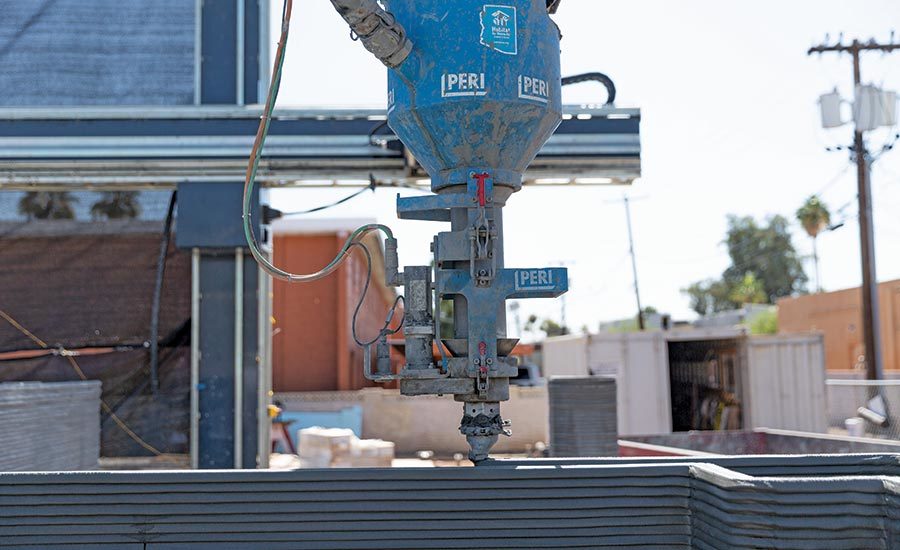 A print nozzle sweeps back and forth around a small plot in Tempe, Ariz., and the walls of a single-family home begin to take shape. 